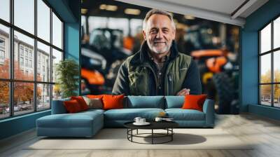 Photo of a tractor salesman standing in a factory and guaranteeing parts and service of agricultural machinery. Daylight on a telephoto lens Wall mural