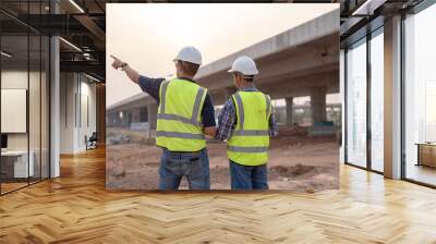 The expressway engineering team inspected the construction work. Asian architects and mature supervisors meeting at the construction site. Workers discuss plans construction workers work together Wall mural