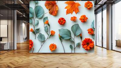 A white background with a variety of orange flowers and leaves Wall mural