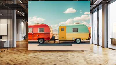 Two colorful RVs are parked next to each other on a road Wall mural