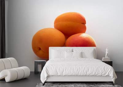 Close-up of three raw apricots Wall mural