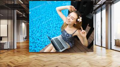 happy woman rest after hard work at swimming pool with laptop, d Wall mural