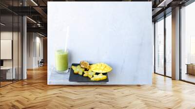 Mango and carambola on plate, kiwi fresh juice. Wall mural