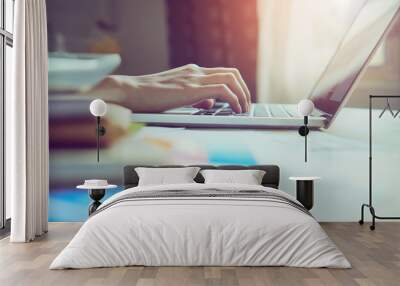 businessman hand working laptop on wooden desk in office in morning light. vintage effect Wall mural