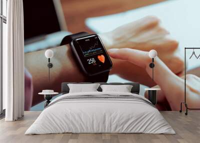 Close up of hand touching smartwatch with health app on the screen, gadget for fitness active lifestyle. Wall mural