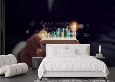 Stock exchange market concept, hand trader holding smartphone with graphs analysis candle line on bokeh colors light in night. Wall mural