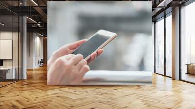 woman using smartphone on staircase in public areas, During leisure time. The concept of using the phone is essential in everyday life. Wall mural