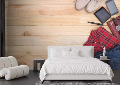 Outfit of traveler, student, teenager, young woman or guy. Overhead of essentials for modern young person. Different objects on wooden background. Wall mural