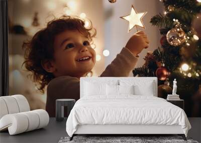 A child placing a star on top of a Christmas tree, with soft lights and ornaments sparkling all around Wall mural