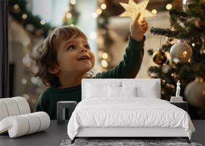 A child Wear a green shirt placing a star on top of a Christmas tree, with soft lights and ornaments sparkling all around Wall mural