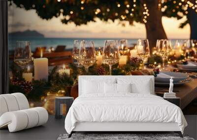 A Christmas table set for a festive feast, with candles, evergreen garlands, and sparkling wine glasses outdoor In the middle of the background By the sea scenery Wall mural