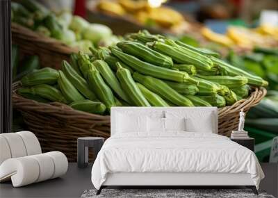 A close-up of fresh okra (Abelmoschus esculentus) in a market basket, ready for sale Wall mural