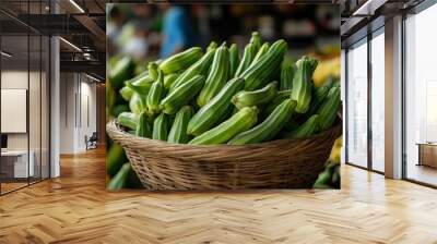 A close-up of fresh okra (Abelmoschus esculentus) in a market basket, ready for sale Wall mural