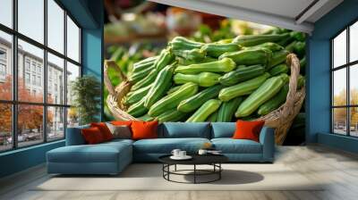 A close-up of fresh okra (Abelmoschus esculentus) in a market basket, ready for sale Wall mural