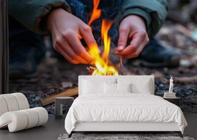 A close-up of hands showing how to light a campfire Make a bonfire . Wall mural