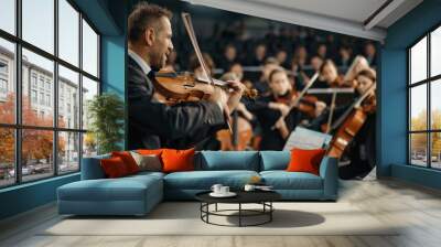 A passionate music teacher conducting an orchestra of enthusiastic students, each playing different instruments, capturing the harmony and unity of a well-coordinated team black suit Wall mural