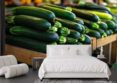 A pile of market-ready zucchini (Cucurbita pepo) on a wooden stand, perfect for summer dishes Wall mural