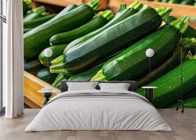 A pile of market-ready zucchini (Cucurbita pepo) on a wooden stand, perfect for summer dishes Wall mural