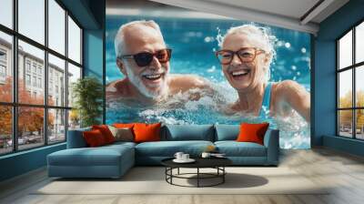 A smiling two man and woman splash happily in a blue pool on a summer day seniors doing water exercises, Group of elder women at aqua gym session, joyful group  Wall mural