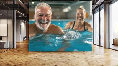 A smiling two man splash happily in a blue pool on a summer day seniors doing water exercises, Group of elder women at aqua gym session, joyful group of friends having aqua class in swimming  Wall mural