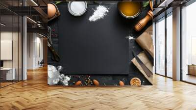 Blackboard with a variety of baking ingredients and cooking utensils on a dark background. Wall mural