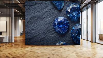 blue sapphire on black coal background. the dark blue gemstone jewelry cut with dark stone background. Wall mural