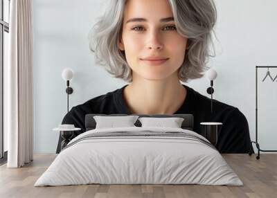 Close up of beautiful woman with white skin, grey short hair, wavy hair and a clear black t shirt, isolated in a light white studio. Portrait person. Wall mural