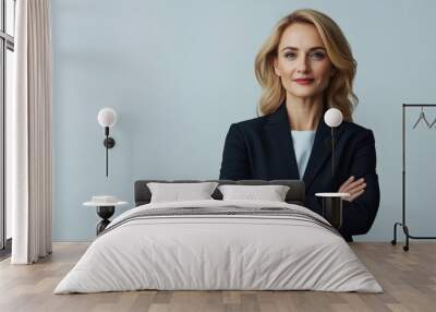 Close up of middle aged businesswoman in a black suit, blonde long hair, stands with crossed arms, smiling at the camera. Successful beautiful lady isolated on a white background, Portrait person Wall mural