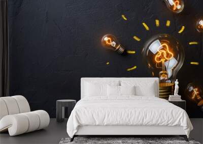 creativity startup business ideas concept with glow light bulb on black background tungsten light bulb lit on black background. Wall mural