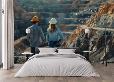 Two engineers in hard hats looking at a large open pit mine Wall mural