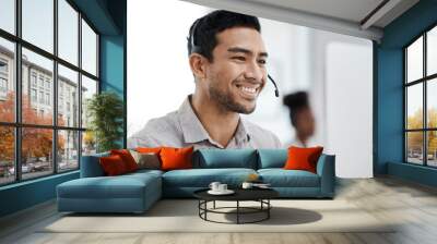 Businessman, call center and smile with headphones in customer service, support or telemarketing at office. Happy asian man consultant agent smiling for online advice, telesales or help at workplace Wall mural