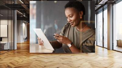 Tablet, credit card and black woman at a coffee shop with technology and ecommerce app. Online shopping, African female person and digital payment in a cafe and restaurant with tech and website deal Wall mural