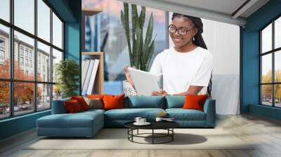 Tablet, happy and business black woman in office online for social media, internet and networking. Professional, corporate and female person on digital technology for website, research and contact Wall mural