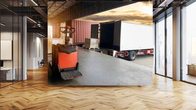 Packaging Boxes on Pallet Loading into Shipping Cargo Container. Trucks Parked Loading at Dock Warehouse. Distribution Center. Supply Chain Shipment Logistics. Cargo Freight Truck Transportation. Wall mural