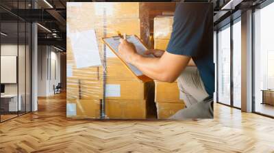 Workers Holding Clipboard is Checking Stock of Packaging Boxes. Cartons, Cardboard Boxes. Warehouse Inventory Management. Supply Chain. Shipment Boxes Shipping Warehouse Logistics. Wall mural