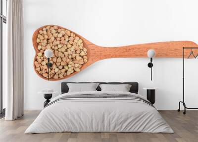 Buckwheat in wooden spoon on white background Wall mural