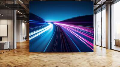 This long exposure photograph showcases vibrant light trails from vehicles on a curved highway during twilight. Wall mural