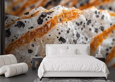 Close-up of a white and orange banded rock with black specks. Wall mural