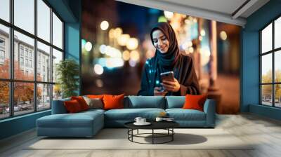 attractive beautiful young arab hijab woman using and texting on her smart phone mobile for service 5g digital communication and online social media city life as wide banner Wall mural