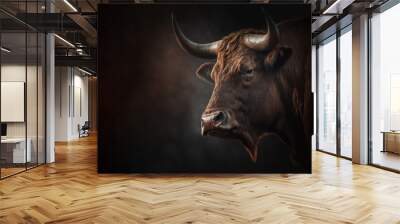 closeup of a head of an angry brown bull or cow profile isolated on dark background Wall mural