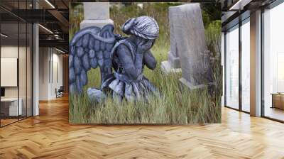 girl wearing an angel costume in an old grave yard Wall mural