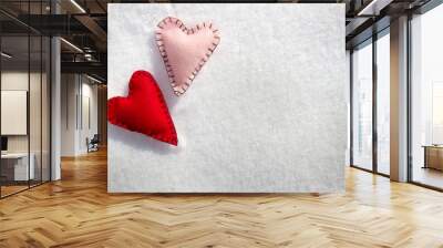 Two stitched hearts on snow Wall mural