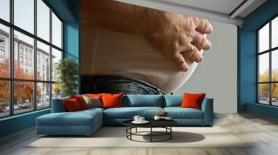 Overweight man with hand on belly Wall mural