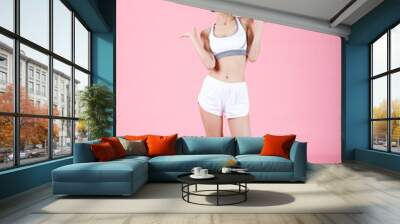 Beautiful young woman open hands and measuring scales after weight loss on color background. Young pretty lady promoter hold hands solutions scales compare measure advertise. Wall mural