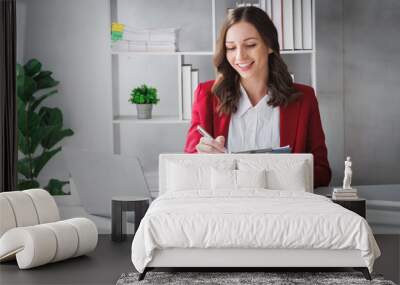 Happy Business woman entrepreneur holding chart working sit at office desk. Portrait of beautiful smiling young businesswoman sitting at modern work station. Wall mural