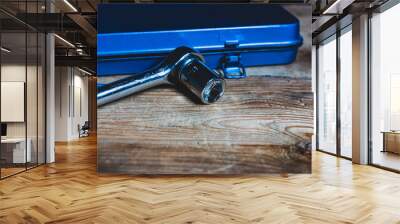 A socket wrench in front of a blue tool box Wall mural