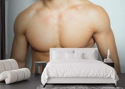 the torso of a young athletic guy. concept: the male body after exercise and diet. men's health: shaved breasts Wall mural