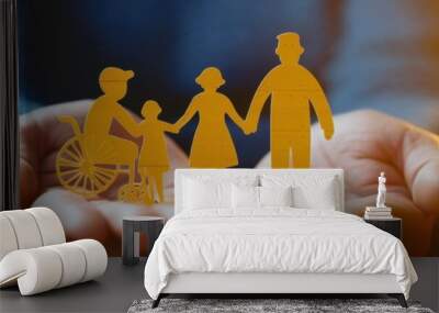 A pair of hands holding yellow paper cutouts representing people, including one person in an empty wheelchair and another with the arms crossed to represent parents or family members Generative AI Wall mural