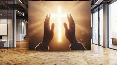 Close-up of hands reaching towards the sky with a glowing cross in the background, light rays shining through the cross, a sunrise, and a white color theme Generative AI Wall mural