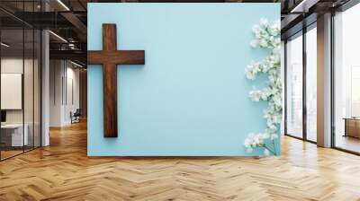 wooden cross and white flowers on a light blue background, representing Christianity banner with copy space Generative AI Wall mural